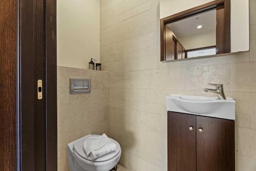a bathroom with a sink and a toilet and a mirror at Beach View - Miramar Pleasure 2BR condo - LV308 in Palm-Eagle Beach