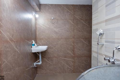 a bathroom with a sink and a shower at Reunion Ocean Waves - Beach House in Udupi