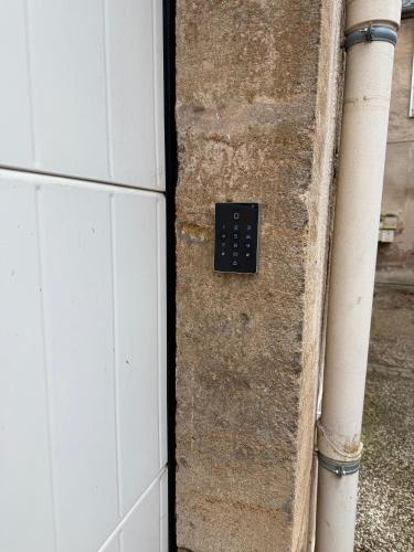 a door with a switch on the side of a building at La Loge Lingonne in Langres