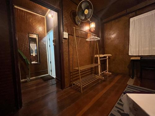a room with a fan on the wall and a staircase at Once in Lampang Guesthouse in Lampang