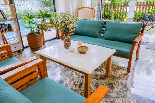 a living room with a couch and a table at Palm Riverside Boutique in Hoi An