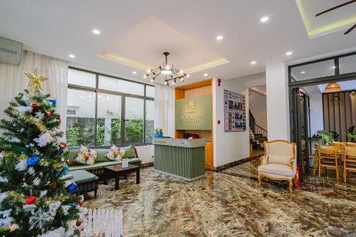 a christmas tree in the lobby of a hotel at Palm Riverside Boutique in Hoi An