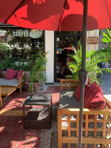 a red umbrella sitting on top of a patio at Suite Home Boutique Hotel in Phnom Penh