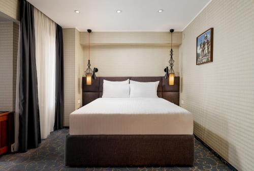 a bedroom with a large bed in a room at Crystal Palace Hotel in Bucharest