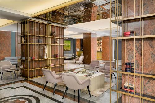 a rendering of a lobby with chairs and a table at Crystal Palace Hotel in Bucharest