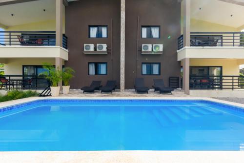 a swimming pool in front of a building at Casa Vista Mar in Río San Juan