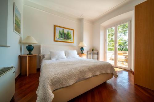 a bedroom with a bed and a large window at Villa Tereza in Čilipi