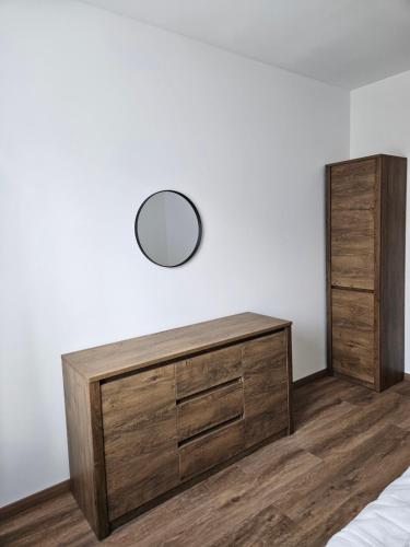 a bedroom with a dresser and a mirror on the wall at Brick House Residence in Poprad