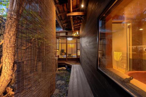 a room with a stone wall and a building at Nijo-Ouan in Kyoto