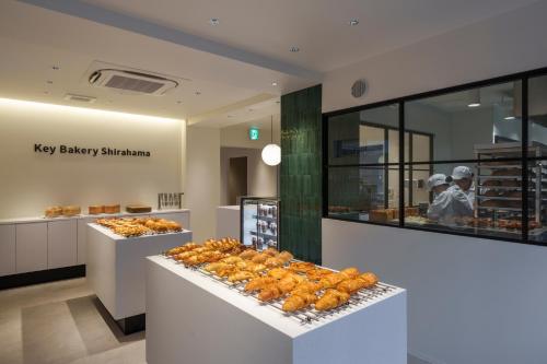 a bakery with a bunch of pastries on display at Bakery Hotel SHIRAHAMA ベーカリーホテル シラハマ in Shirahama
