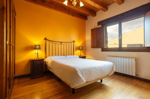 a bedroom with a large bed and a window at Casa rural La Venta Vieja II by CABANA Rentals in Ortigosa del Monte