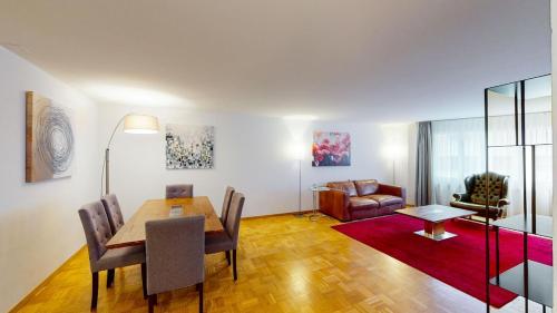 a living room with a table and a couch at Fantastic 2BD 110sqm Flat - Mainau 10 in Zürich