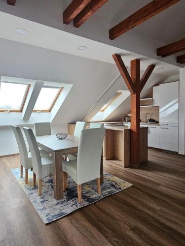 a dining room with skylights and a table and chairs at Brick House Residence in Poprad