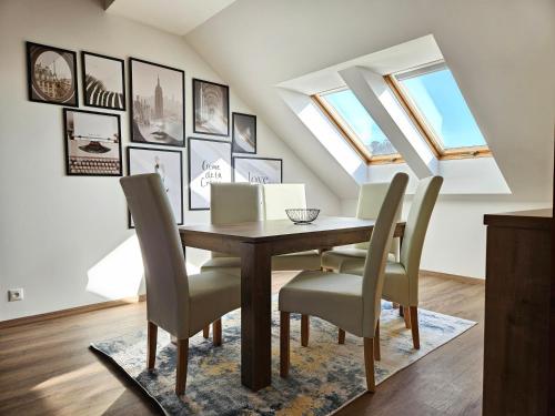 a dining room with a table and chairs at Brick House Residence in Poprad