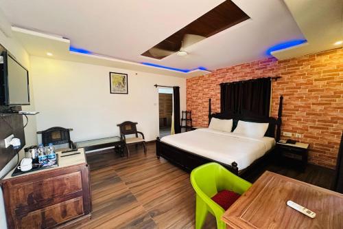 a bedroom with a bed and a table with a chair at Tiger Safari Resort, Ranthambhore in Sawāi Mādhopur
