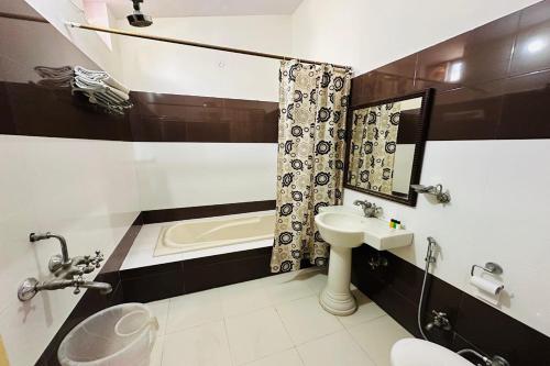 a bathroom with a sink and a toilet and a tub at Tiger Safari Resort, Ranthambhore in Sawāi Mādhopur