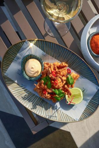 a plate of food on a table with a plate of food at ME Malta by Meliá in St Julian's