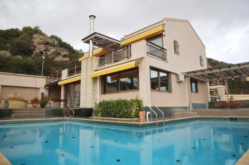 a house with a swimming pool in front of a house at Villa 47 in Keratea