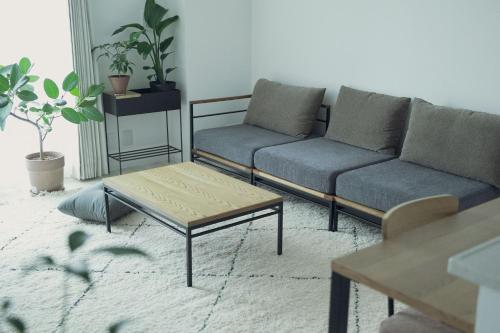 a living room with two couches and a coffee table at famSAPPORO 主要観光地が徒歩圏内の好立地 in Sapporo