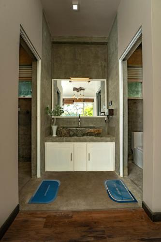 a bathroom with a sink and a mirror at The Quale Villa in Galle