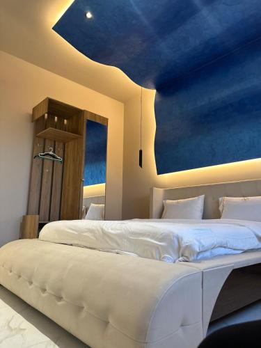 a bedroom with two beds with a blue ceiling at 3A villa in Rrushkull