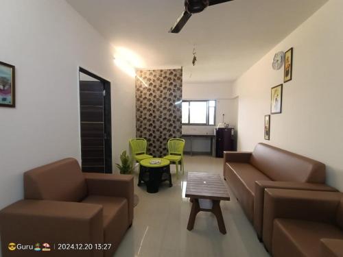 a living room with a couch and a table at Horizon Grande Apartments - Tarkarli in Malvan