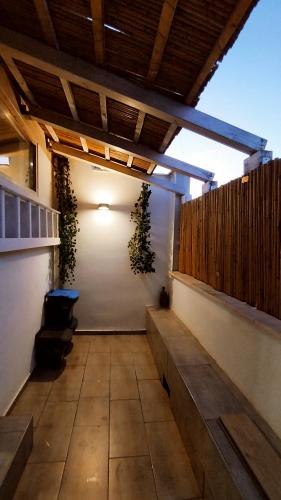 a patio with two potted plants on the wall at Alle Volte Maison in Grumo Appula