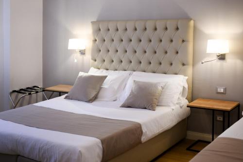 a bedroom with a large bed with a large headboard at Domus Uffizi in Florence