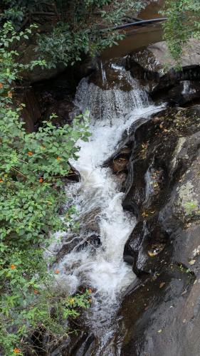 a stream of water running down a rocky slope at Siri Serenity by Illika in Tarikere