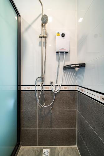 a shower in a bathroom with a shower head at cozy one-bed Room suit in Venice Villa in Ban Huai Yai