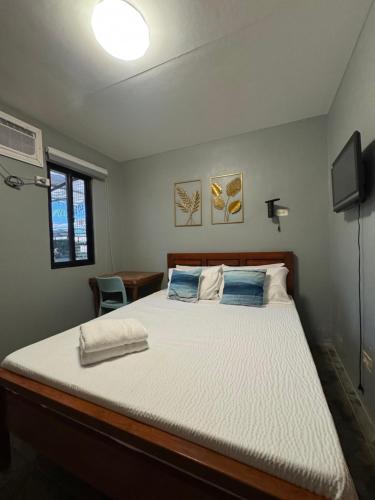 une chambre avec un lit et une télévision dans l'établissement Mai Resort Hotel, à Laoac