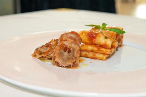 a plate of food on a white plate at Roses Hotel in Roseto degli Abruzzi