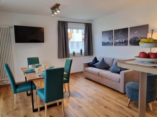 a living room with a table and a couch at Gröbl-Alm in Mittenwald