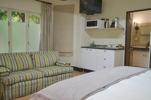 a living room with a couch and a kitchen at 4 Piet Retief in Stellenbosch