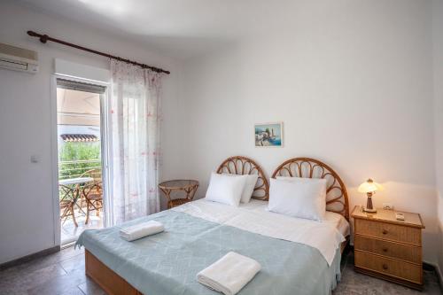 a bedroom with a bed and a balcony at Villa Mira in Pefkohori