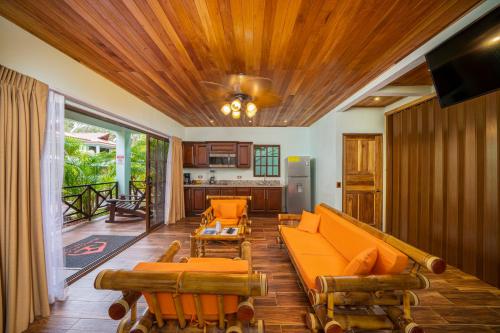 a living room with a couch and chairs in it at Bungalows Punta Uva in Punta Uva