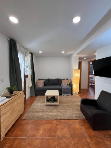 a living room with a couch and a table at Rincón de Anayet Entrada Autónoma Formigal in Formigal