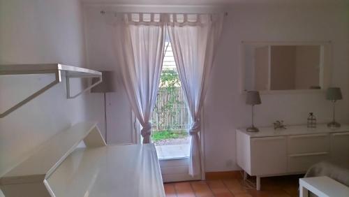 a white room with a window and a staircase at Bastide la Bohême in La Ciotat