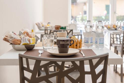 a table with a plate of food and a coffee mug at MarGab B&B in Naples