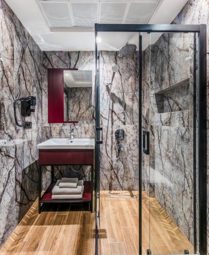 a bathroom with a shower and a sink at Heaven Premium Hotel Restaurant & Airport Shuttle in Arnavutköy