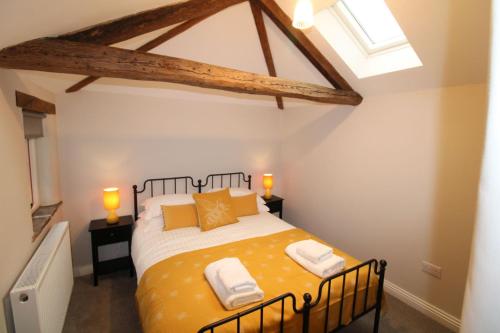 a bedroom with a large yellow bed in a room at South View Cottage Dacre in Dacre