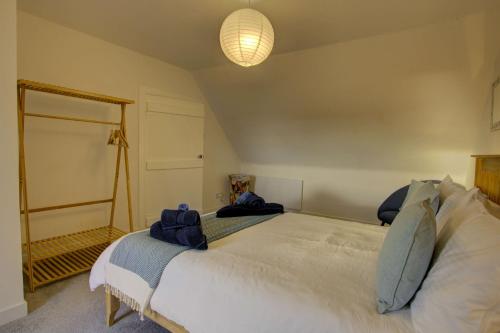 a bedroom with a large bed and a mirror at Tigh-na-mara, Helmsdale in Helmsdale