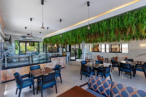 IsioloIman Hotel的有桌椅和酒吧的餐厅