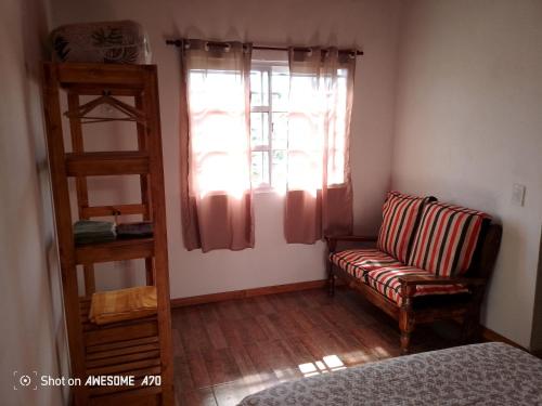 a living room with a couch and a window at Lo de tina in Florencio Varela