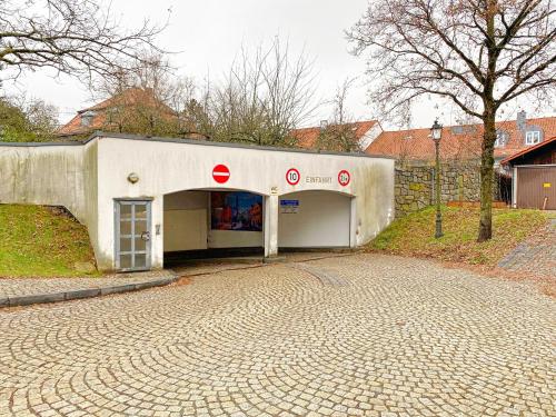 a white building with a door on a brick road at !GoldPath! Loft - Exclusiv - XXL - Central - Sauna - Tiefgarage - Cozy in Waldkirchen