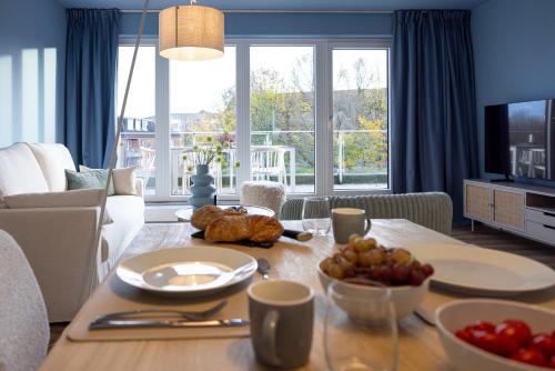 a living room with a table with food on it at Penthouse Flensburg in Flensburg