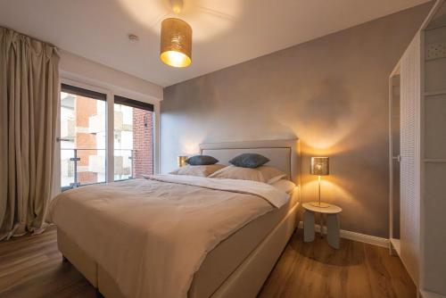 a bedroom with a large bed and a window at Penthouse Flensburg in Flensburg