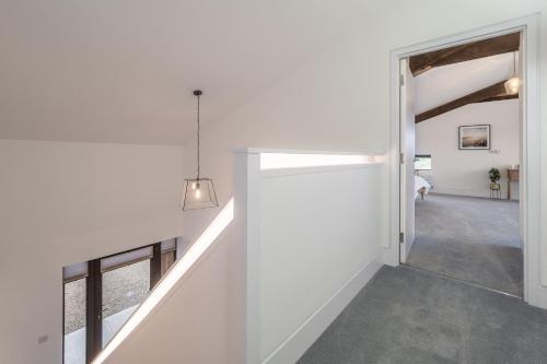 a hallway of a house with an open door at Mandalore 4 in Sotherton