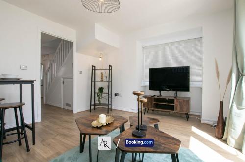 a living room with a tv and a table at Cozy House By AR Properties Short Lets & Serviced Accommodation Colchester in Colchester