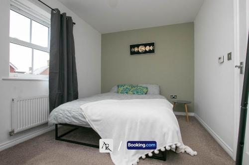 a small bedroom with a bed and a window at Cozy House By AR Properties Short Lets & Serviced Accommodation Colchester in Colchester
